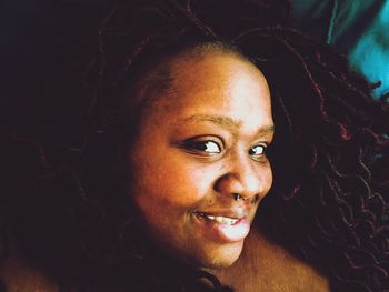 Close-up portrait of smiling young woman