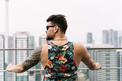 Young man standing in city