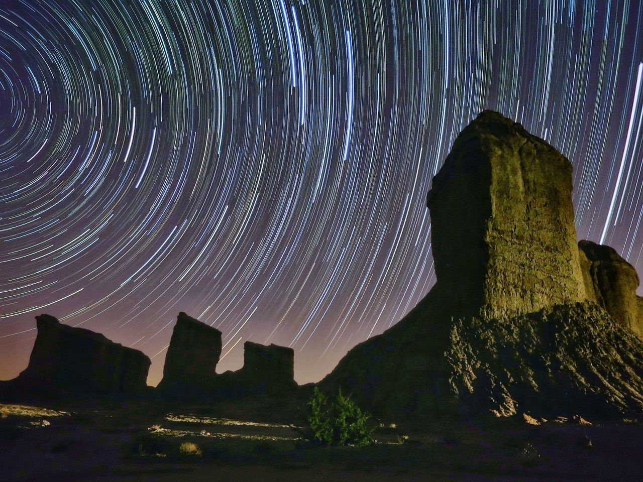 VIEW OF ILLUMINATED ROCK FORMATION AT NIGHT