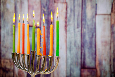 Close-up of multi colored candles on wooden table