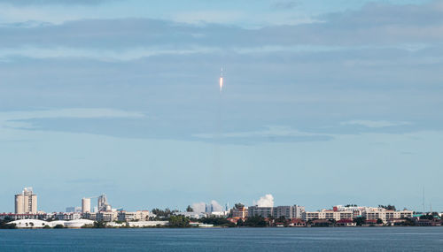 Scenic view of sea and buildings against sky