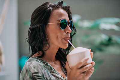 Portrait of young woman drinking coffee