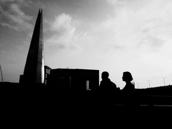 Low angle view of silhouette built structure against sky at sunset