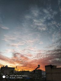 Low angle view of buildings against sky during sunset