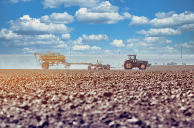 Tractor plowing field. tractor plow soil cultivating. cultivated land and soil tillage. 