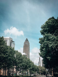 Low angle view of trees and buildings against sky