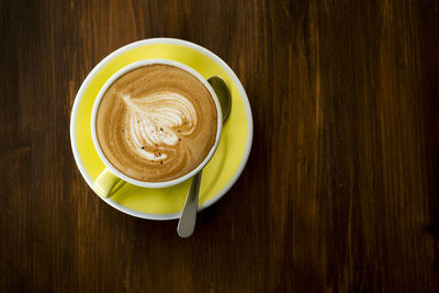 Directly above shot of cappuccino served on table