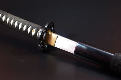 Close-up of sword on table