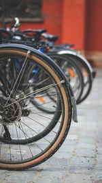 Close-up of bicycle parked on footpath