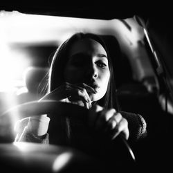 Beautiful woman sitting in car at night