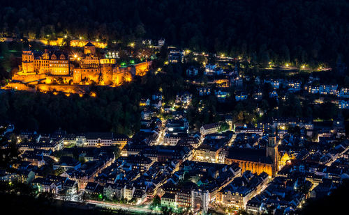 High angle view of city lit up at night