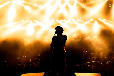 Silhouette of man performing at music concert