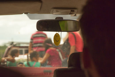 Family seen through car windshield