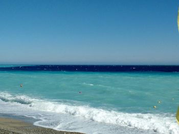 Scenic view of sea against blue sky