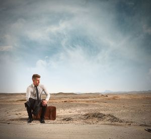 Full length of man sitting on land