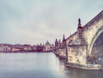 Bridge over river with buildings in background