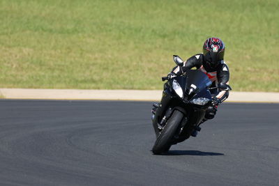 Man riding motor scooter on road