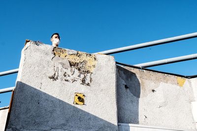 Low angle view of woman against clear sky