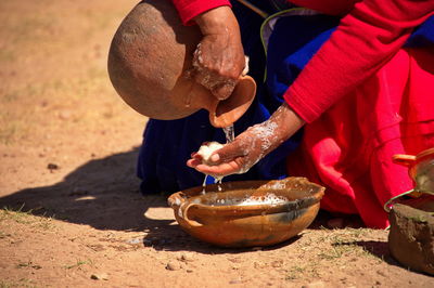 Traditional customs on the island of taquile. a woman makes soap from natural materials