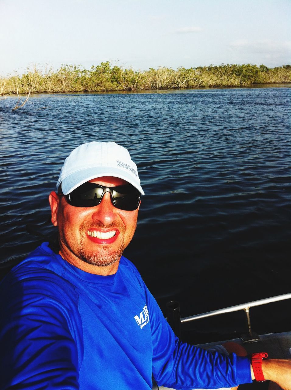 water, lifestyles, lake, leisure activity, transportation, nautical vessel, casual clothing, river, boat, blue, clear sky, mode of transport, sunglasses, men, person, reflection, sitting, young adult