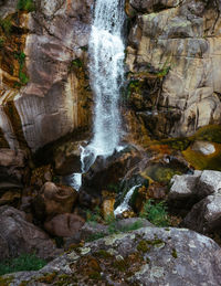 View of waterfall along rocks