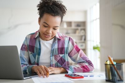 Young woman using laptop at office