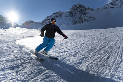 Full length of man skiing on snowcapped mountain