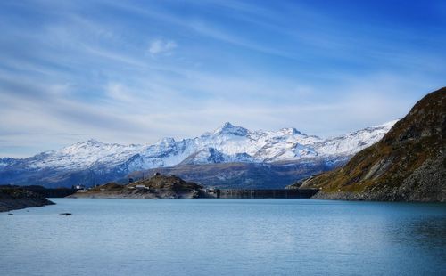 Scenic view of lake and snowcapped mountains against sky