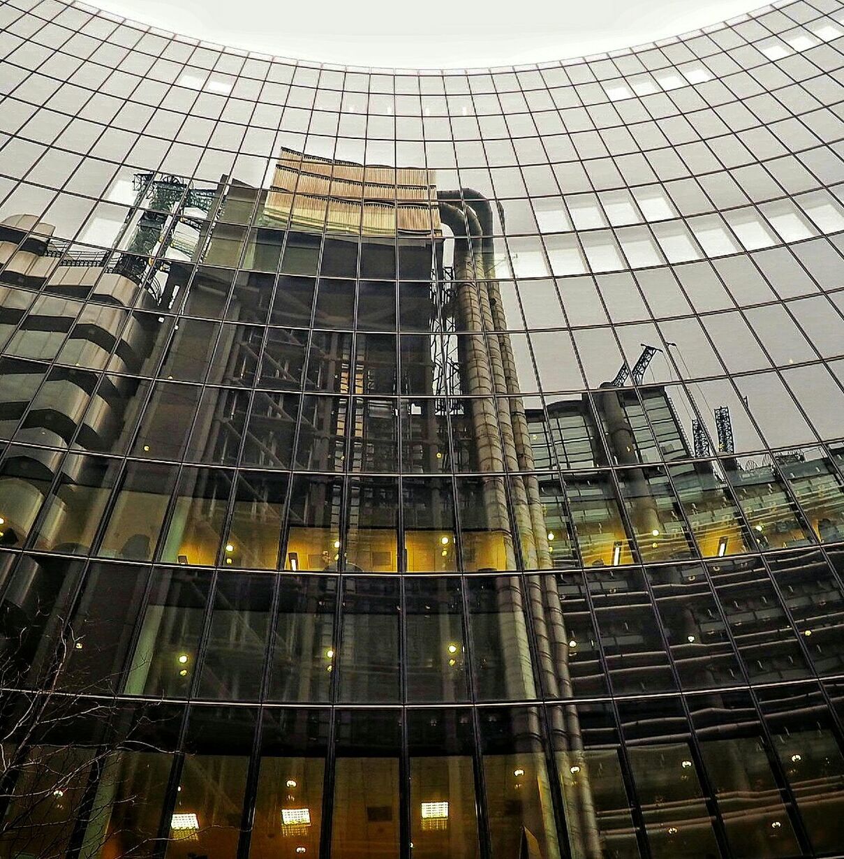 architecture, building exterior, built structure, skyscraper, city, tall - high, modern, office building, tower, low angle view, glass - material, building, capital cities, sky, development, city life, reflection, financial district, cityscape, tall