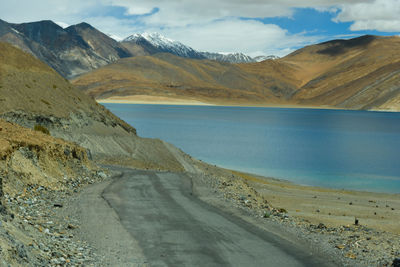 Scenic view of sea and mountains against sky