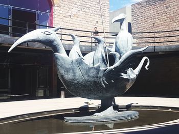 Statue of bird on wall