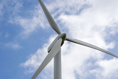 Low angle view of windmill against sky