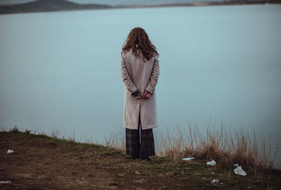 Rear view of woman looking at lake