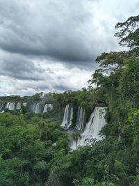 Scenic view of waterfall against sky