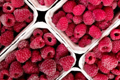 Directly above shot of raspberries in containers for sale at market
