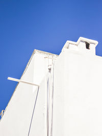 Low angle view of building against clear blue sky