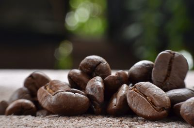 Close-up of roasted coffee beans on table