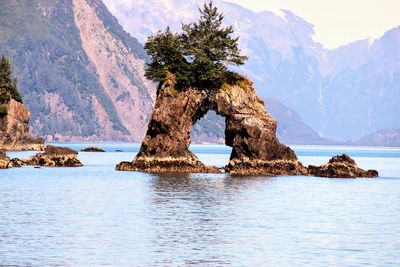 Scenic view of rocks in sea against sky