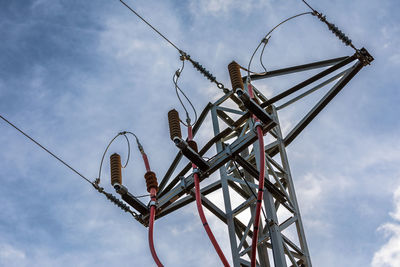 Low angle view of electricity pylon against sky