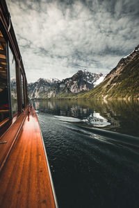 Scenic view of lake by mountains against sky