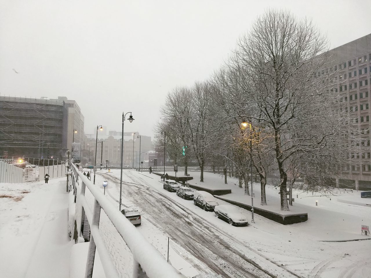 PANORAMIC VIEW OF SNOW COVERED CITY BUILDINGS