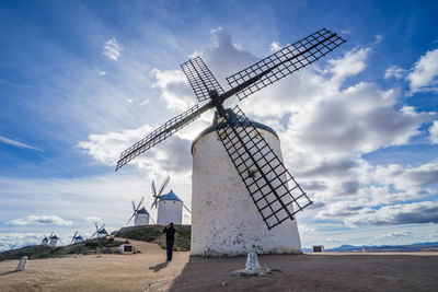 Traditional windmill on field against sky