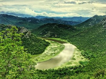 High angle view of green mountains and lake