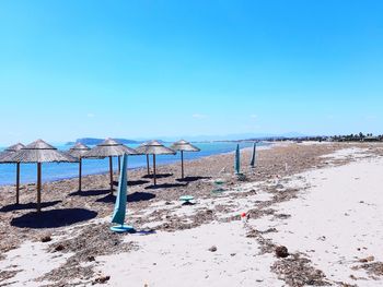 Scenic view of beach against clear blue sky