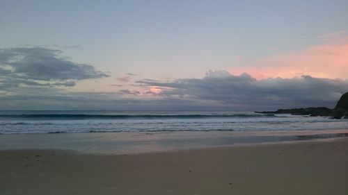 Scenic view of beach against sky during sunset