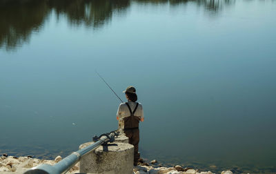 Rear view of man standing in water