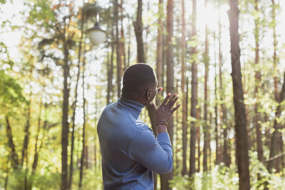 Rear view of man in forest