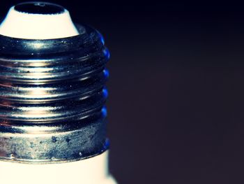 Close-up of a stack of blue metal against black background