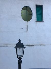 Low angle view of street light against building