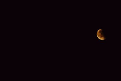 Low angle view of moon in sky at night